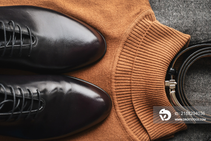 Close of fashionble men dark red leather shoes with tweed blazer  and brown sweater. Top view.