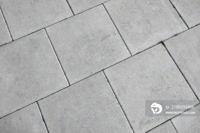 View of the gray pedestrian tiles in the city.