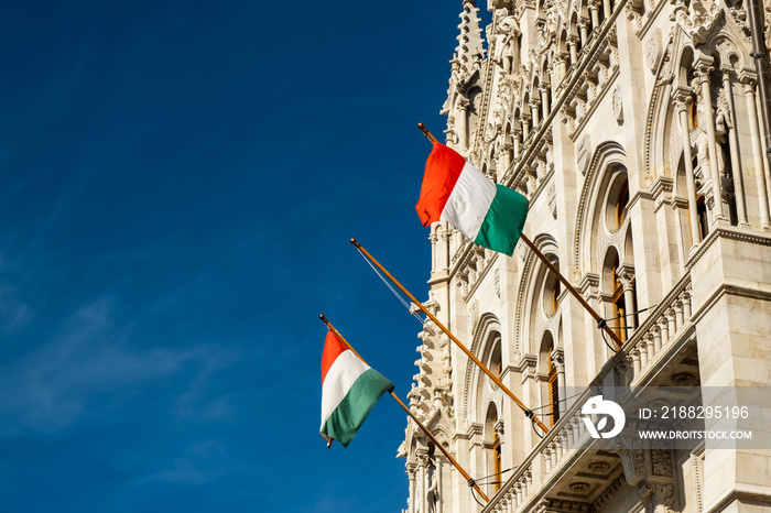 Hungarian flags on the Hungarian Parliament Building or Parliament of Budapest, a landmark and popular tourist destination in Budapest, Hungary