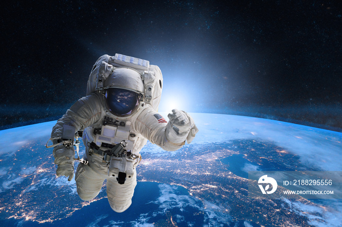 Astronaut in outer space on background of the Earth. Elements of this image furnished by NASA.