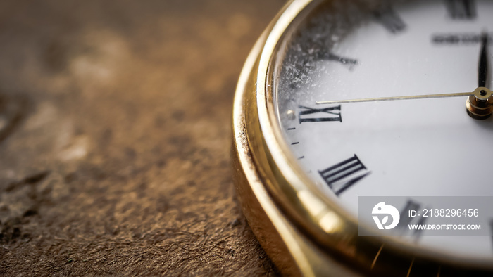 Close up front view of a modern wrist watch on the table. Soft focus. Free space for text