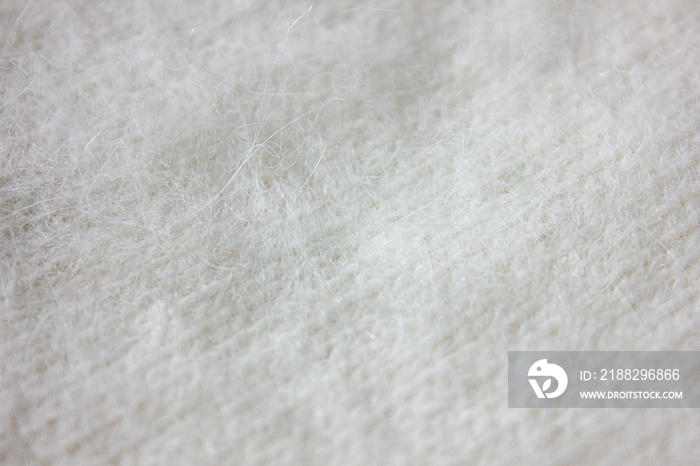 Background Texture of white pattern Knitted Fabric made of Angora or wool close up. White kashmir Background.