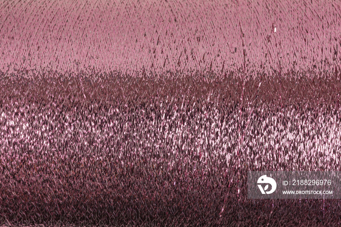 background of pink lurex wool on a cone