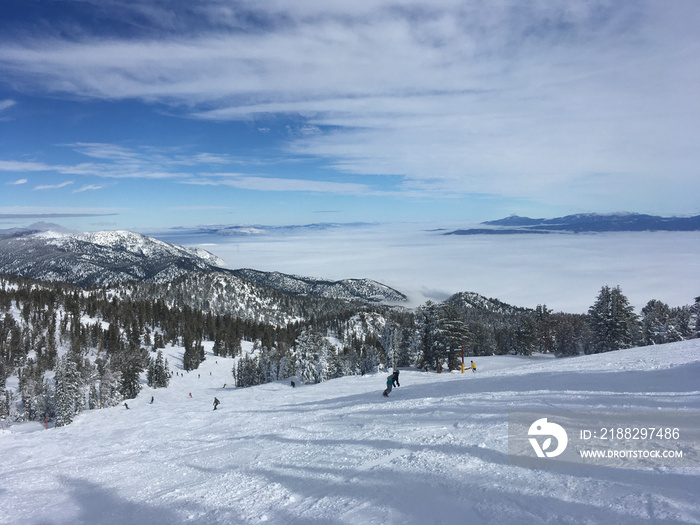 Winter landscape view over Carson Valley hidden underneath clouds, as seen from Heavenly mountain on a cloudy day