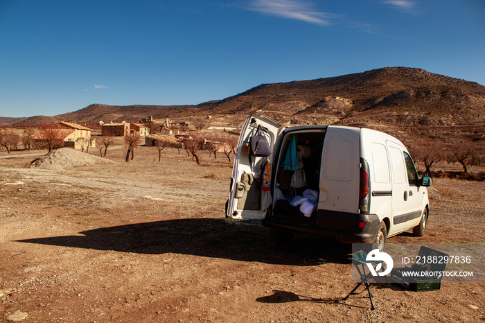 Van life explorer tourist parked outside abandoned village in Teruel Spain