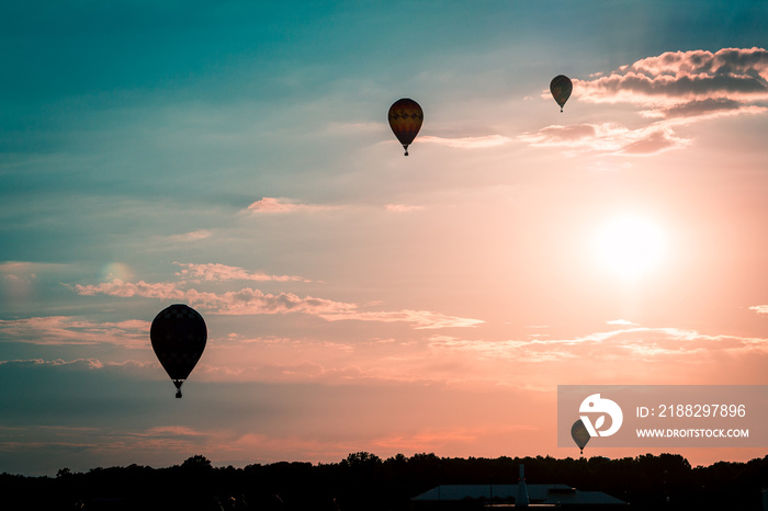 Hot air balloons soaring through the air at sunset in Battle Creek Michigan