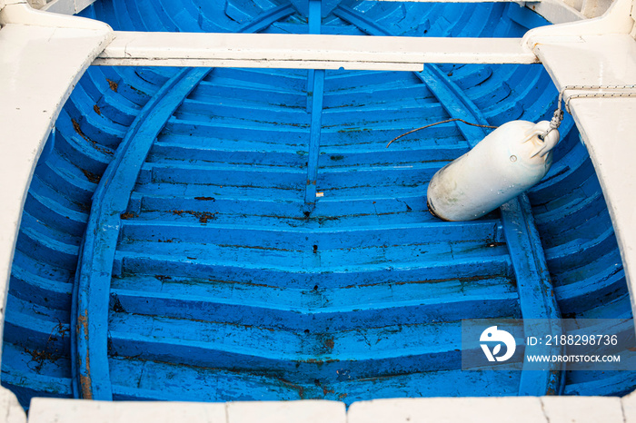 Decrepit old row boats in the harbor in Naples, Italy during the morning following a rain storm.