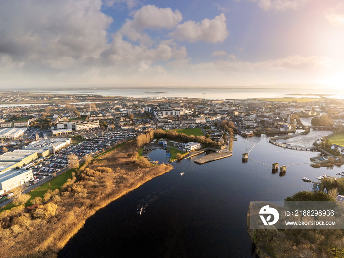 Aerial view on Galway city and river Corrib, Boats practicing, sunset time, Cloudy sky, Ireland, West coast.