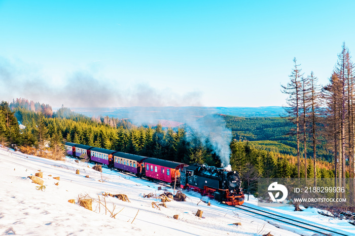 Harz national park Germany, historic steam train in the winter, Drei Annen Hohe, Germany,Steam locomotive of the Harzer Schmallspurbahnen in wintertime with snow.