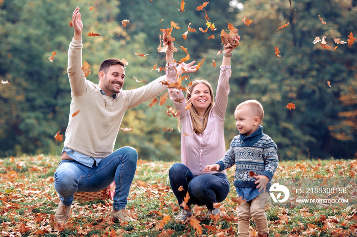 Happy family enjoying in autumn park