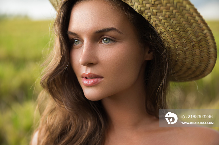 Young lovely woman wearing straw hat