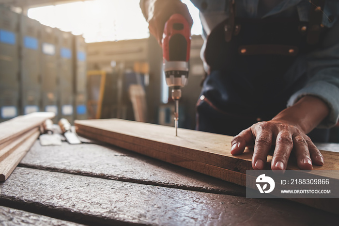 Carpenter working with equipment on wooden table in carpentry shop. woman works in a carpentry shop.