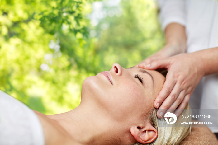 beauty, wellness and relaxation concept - close up of beautiful young woman lying with closed eyes a