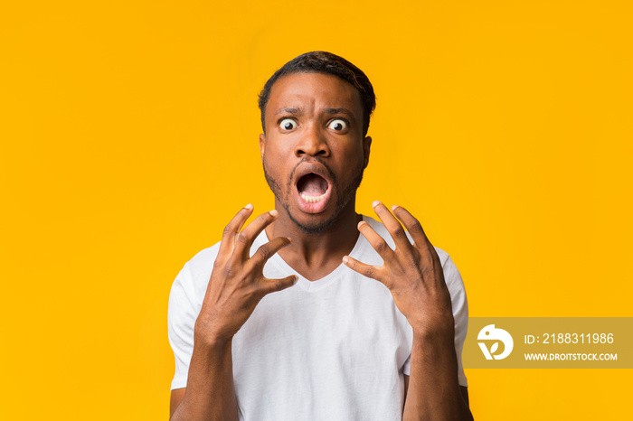 Frightened Black Man Screaming Looking At Camera Standing In Studio