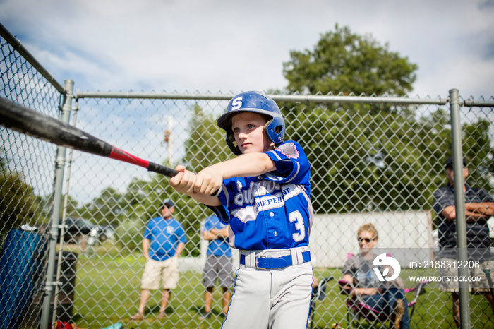 Boy playing baseball in field