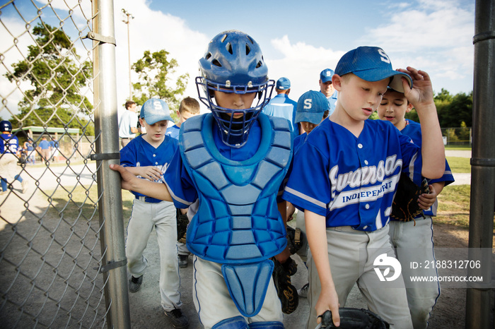 Baseball players leaving baseball field