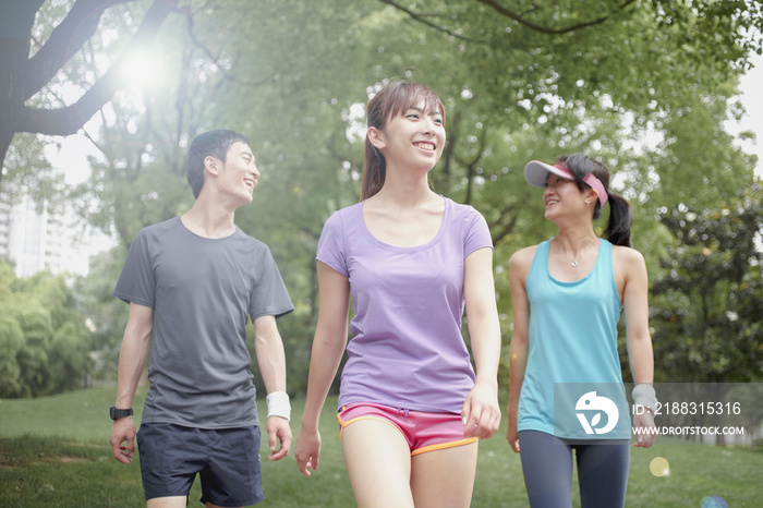 Three young joggers in park