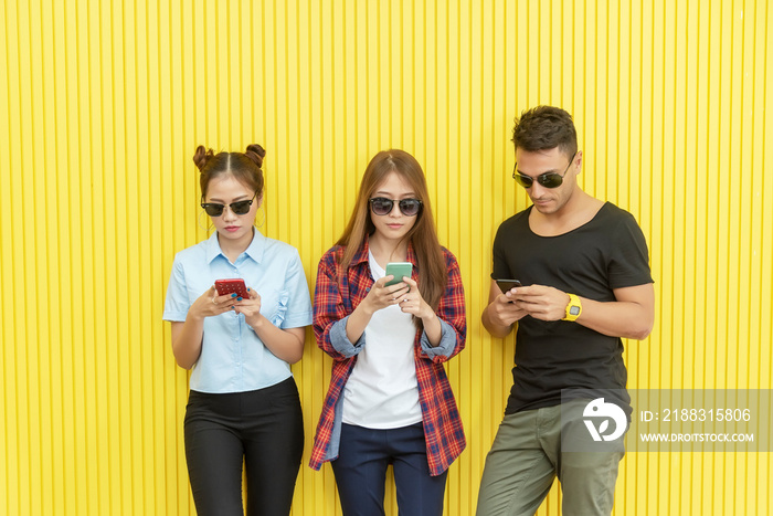 Group of young people using smartphone on wall. Network connection technology concept with free spac