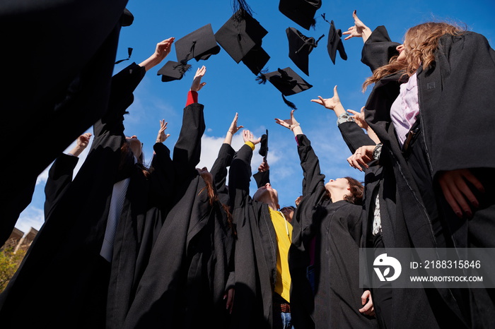 Group of diverse international graduating students celebrating