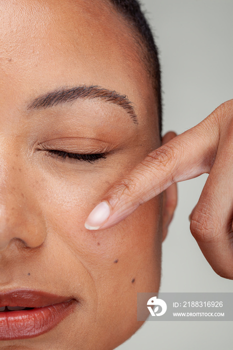 Close-up�of woman with eyes closed touching face