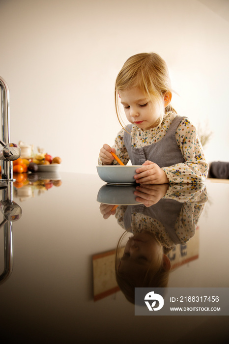 Girl having breakfast at table