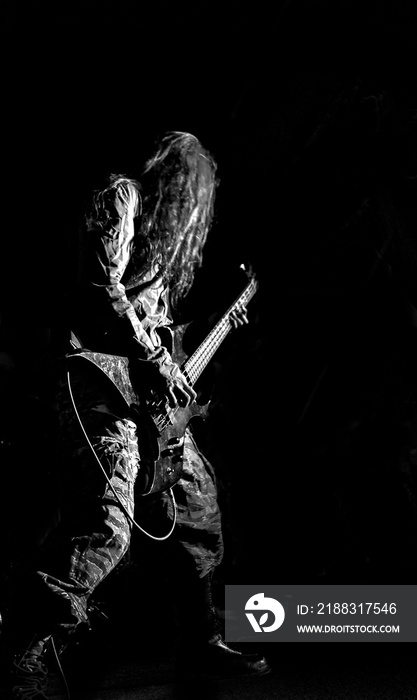 Metal rock guitarist in black background