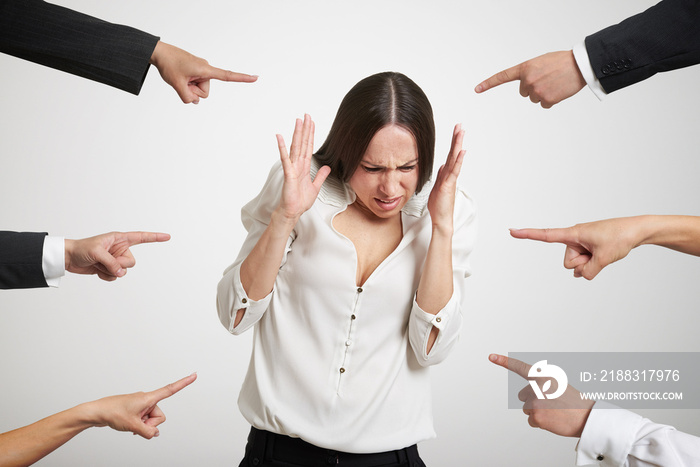 fingers pointing at stressed businesswoman