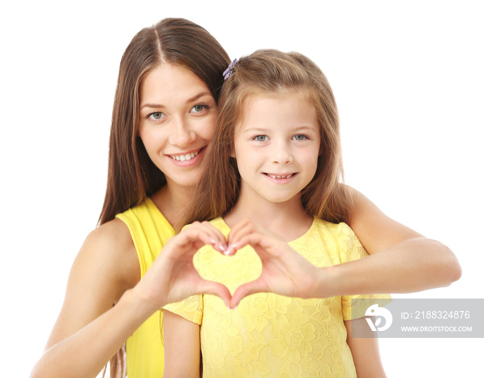 Cute girl and mother holding hands in heart shape on white background