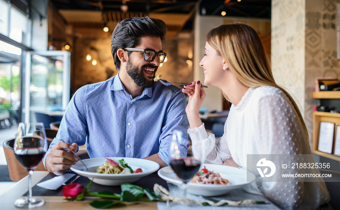 Paste and red wine. Young couple enjoying lunch in the restaurant. Lifestyle, love, relationships, f