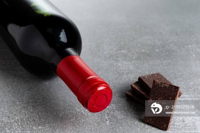 Wine and chocolate on concrete background. Copy Space.