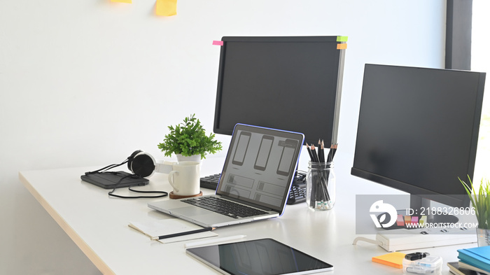 Workspace programmer with laptop and computer pc on table.