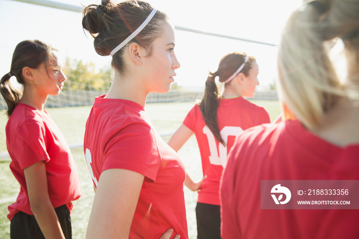 Girl soccer players standing together.