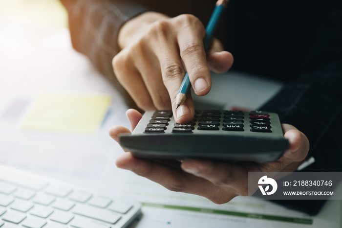 Close up Business woman using calculator and do math finance on workplace in office and business wor