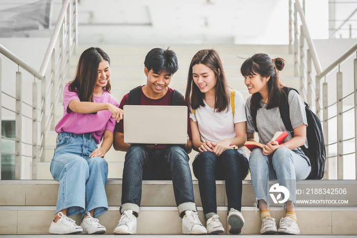 Educational technology and teenage concepts. Group of students sit on the staircase to find informat