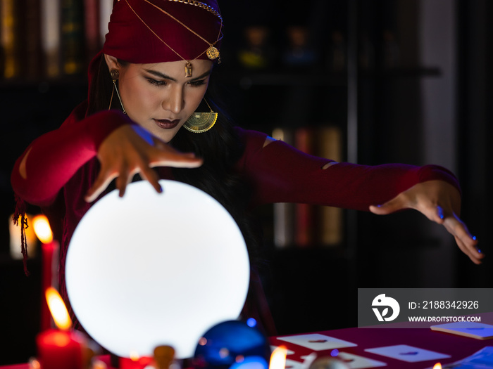 Asian witch using crystal ball to see future