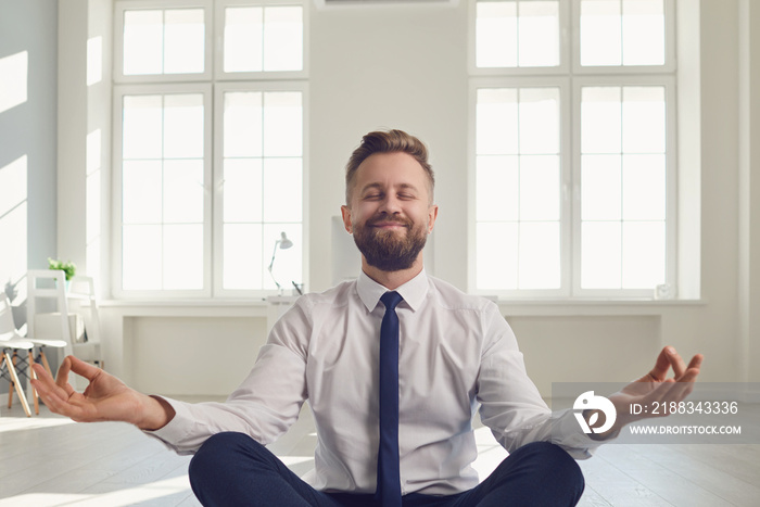 Businessman meditates at the workplace in the office.