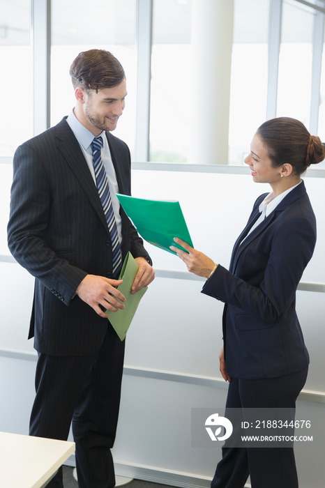 Corporate business people discussing paperwork in office