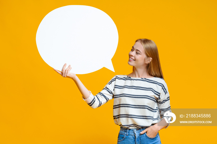 Blank speech bubble in hands of beautiful young girl