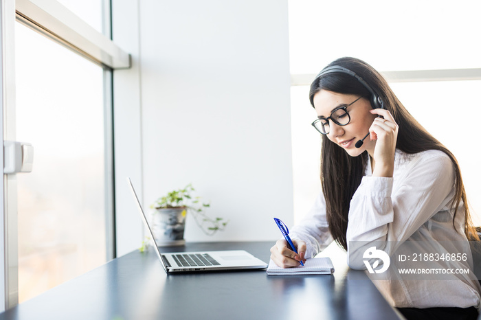 Businesswoman with headset  in call center and make notice