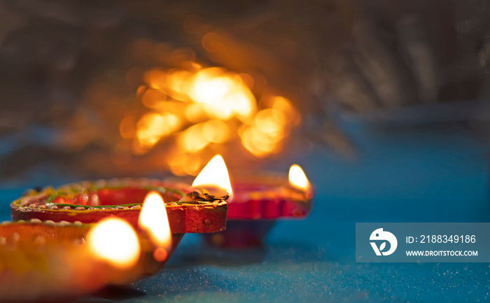 Beautiful clay diya lamps lit during diwali celebration, selective focus