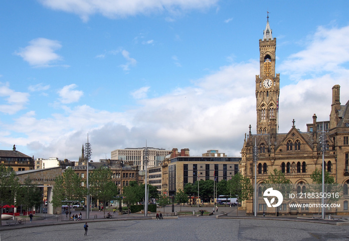 a cityscape view of centenary square and town centre in bradford west yorkshire with people sitting 