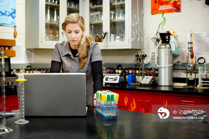 Brewery technician using laptop in laboratory