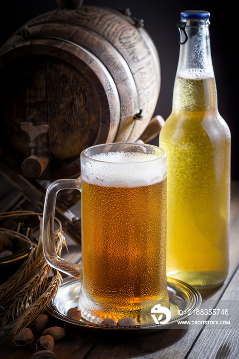 Light beer in a glass on a table in composition with accessories on an old background