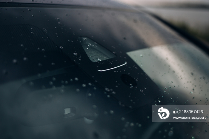 Rain and light sensor on the windshield of the car