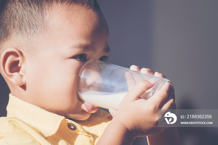 close up of asian young boy drinking milk.