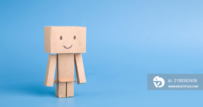 Handmade cardboard robot on blue panorama background