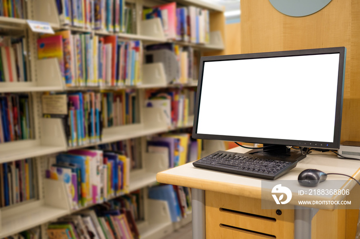 Computer with blank screen monitor on table in interior school library