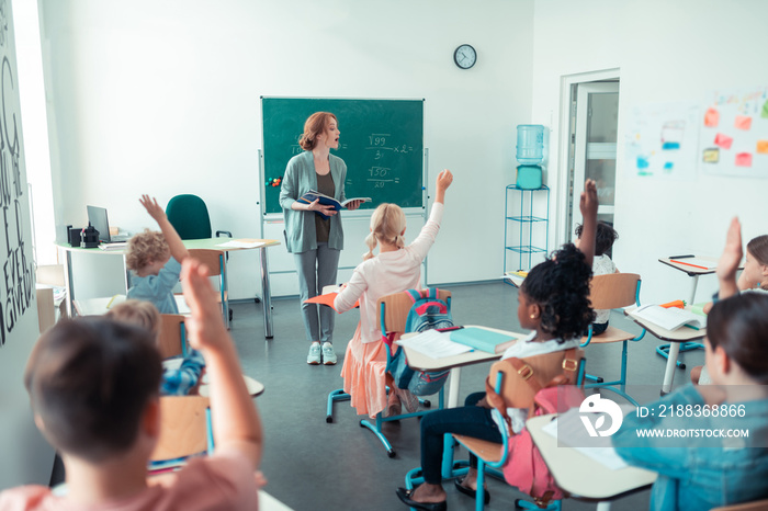 Maths teacher calling a pupil to the blackboard.