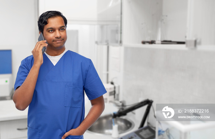 healthcare, profession and medicine concept - happy smiling indian doctor or male nurse in blue unif