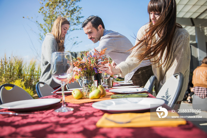 Friends arranging table for party in garden